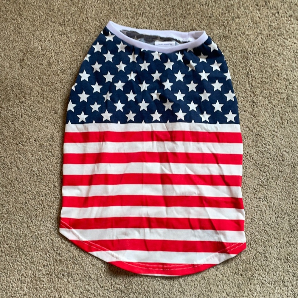 American flag dog shirt fits more like a medium. Worn once